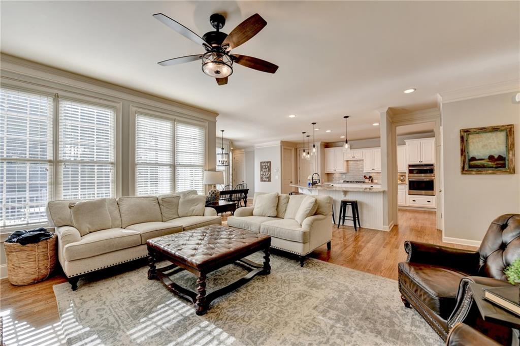 7051 Dove Point Lane Hoschton, GA 30548 - Photo 24 of 74 a living room with furniture kitchen view and a large window