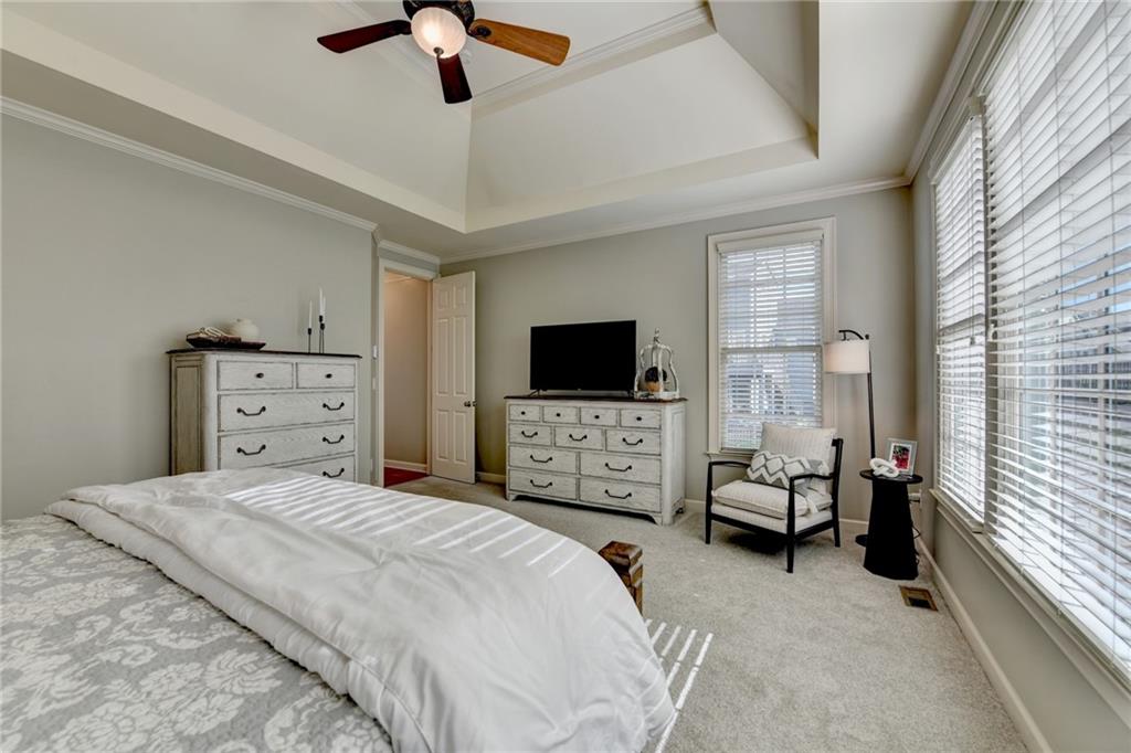7051 Dove Point Lane Hoschton, GA 30548 - Photo 28 of 74 a bedroom with a bed and a flat screen tv