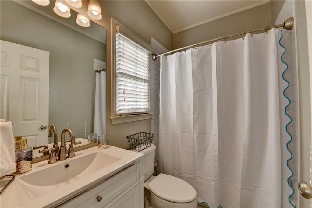 7051 Dove Point Lane Hoschton, GA 30548 - Photo 37 of 74 a bathroom with a sink a toilet and shower curtain