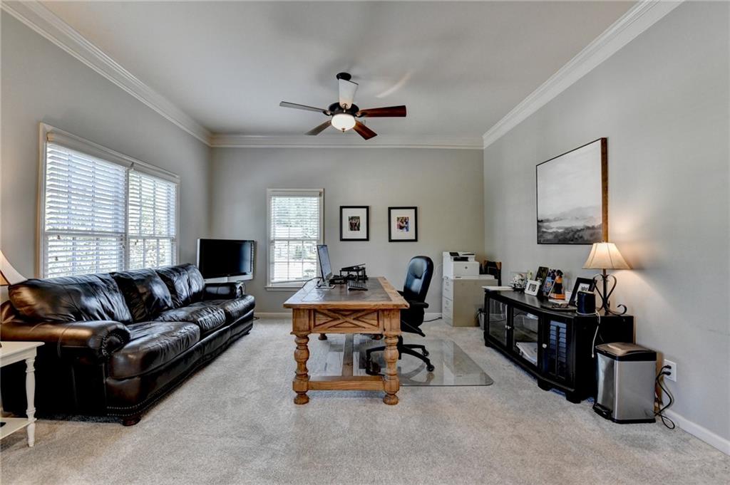 7051 Dove Point Lane Hoschton, GA 30548 - Photo 38 of 74 a living room with furniture and wooden floor