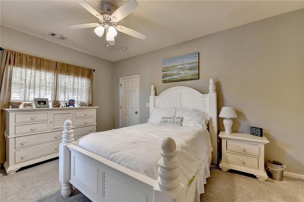 7051 Dove Point Lane Hoschton, GA 30548 - Photo 40 of 74 a bedroom with a bed and window