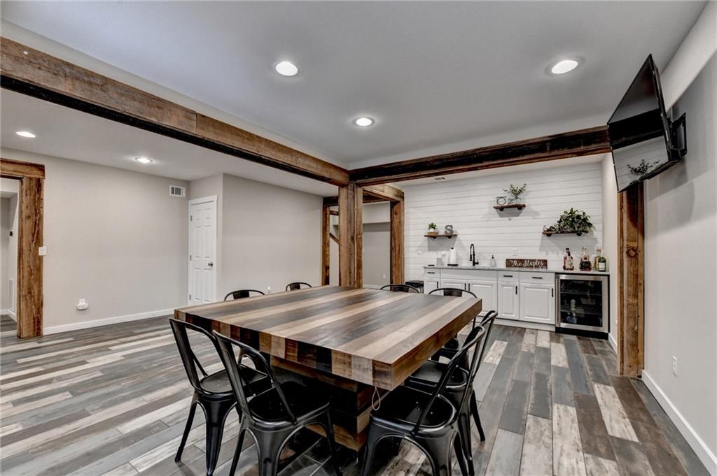 7051 Dove Point Lane Hoschton, GA 30548 - Photo 50 of 74 a view of a dining room with furniture and wooden floor