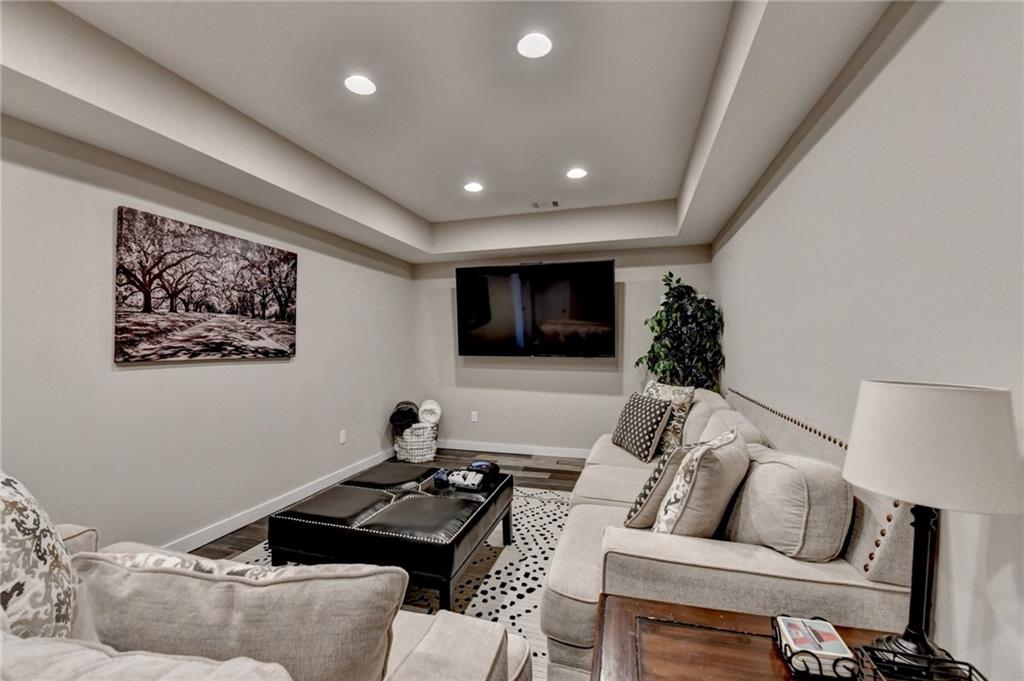 7051 Dove Point Lane Hoschton, GA 30548 - Photo 54 of 74 a living room with furniture and a flat screen tv