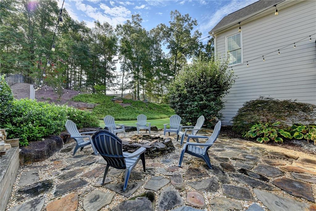 7051 Dove Point Lane Hoschton, GA 30548 - Photo 62 of 74 a view of a chairs and table in backyard
