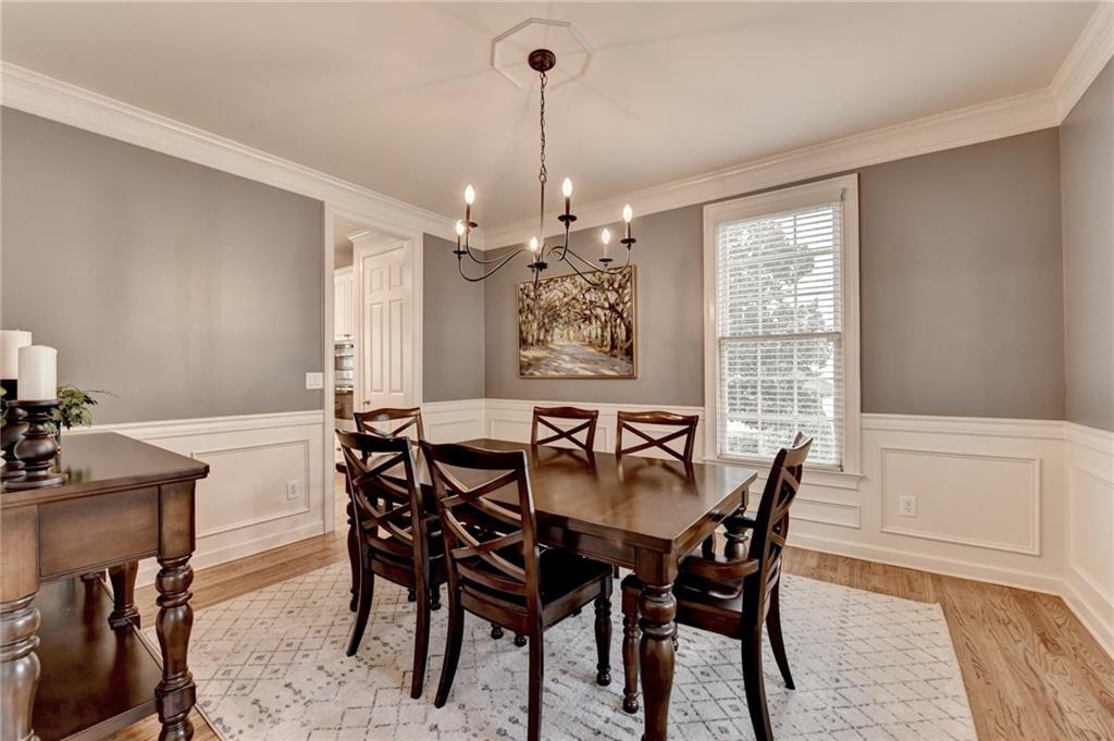 7051 Dove Point Lane Hoschton, GA 30548 - Photo 10 of 74 a view of a dining room with furniture window and wooden floor