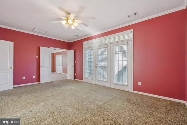 a view of an empty room with a ceiling fan