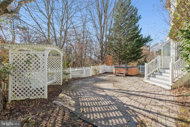 a view of a yard with plants and trees