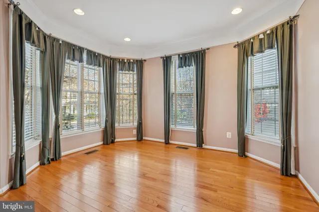 a view of an empty room with glass door and a window
