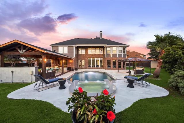 a front view of a house with sitting area and garden