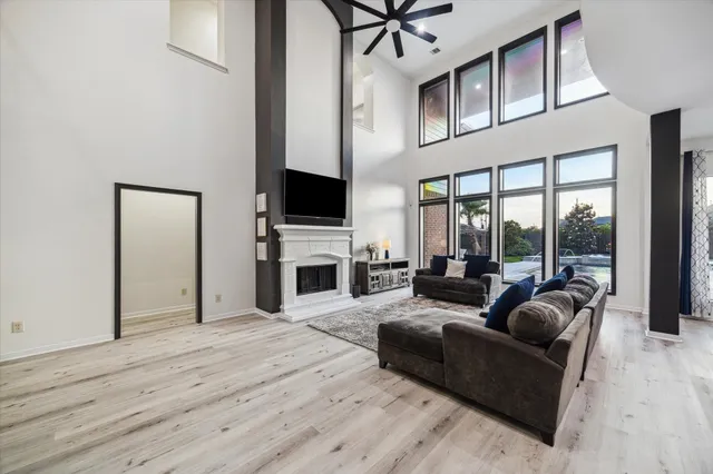 a living room with furniture a fireplace and a flat screen tv