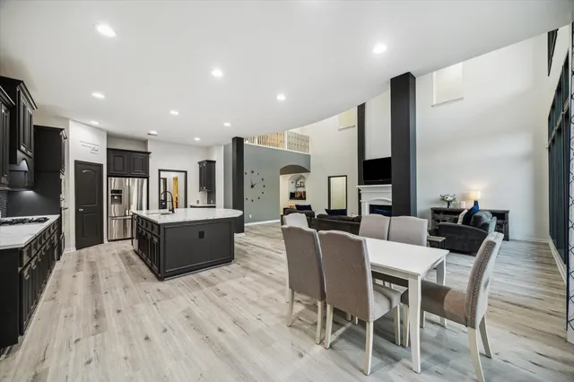 a large kitchen with a table and chairs in it