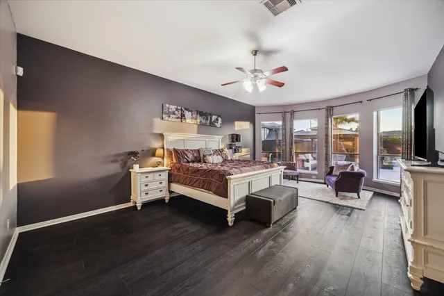 a living room with furniture and a ceiling fan