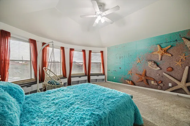 a bedroom with a bed and a large window