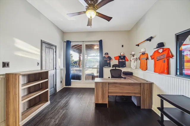 a view of a workspace with furniture and wooden floor