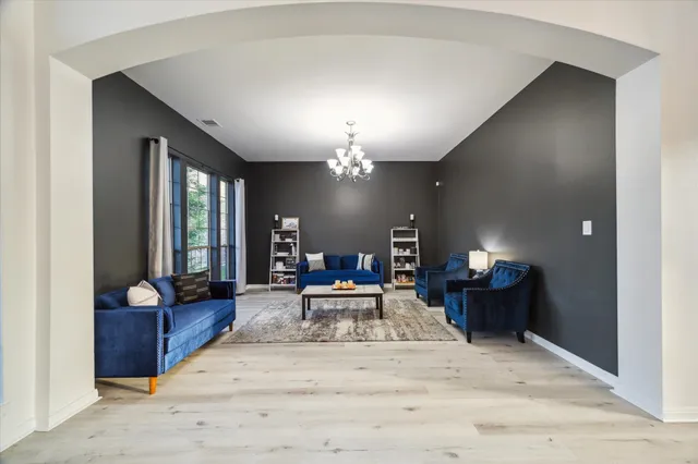 a view of a livingroom with furniture window and wooden floor