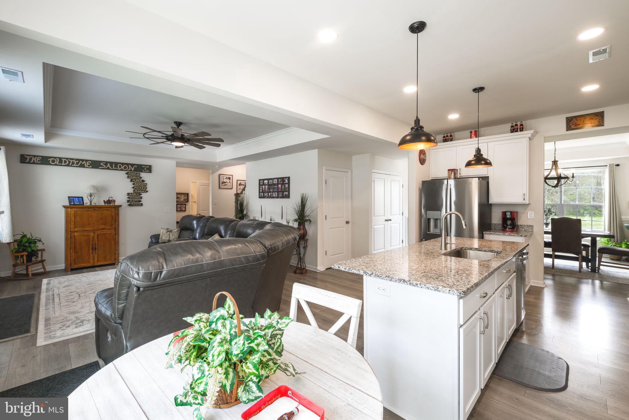 28008 King Farms Road Laurel, DE 19956 - Photo 11 of 44 a large living room with stainless steel appliances kitchen island granite countertop furniture and a view of kitchen