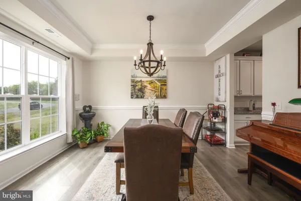 a dining room with furniture a window and a chandelier