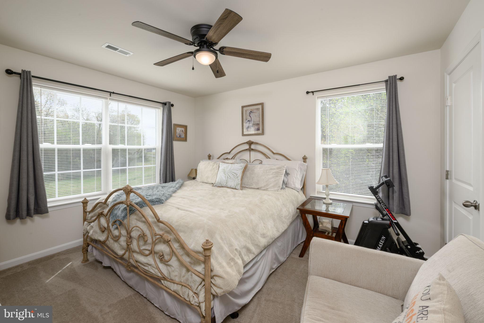 28008 King Farms Road Laurel, DE 19956 - Photo 22 of 44 a bedroom with a bed a window and a couch