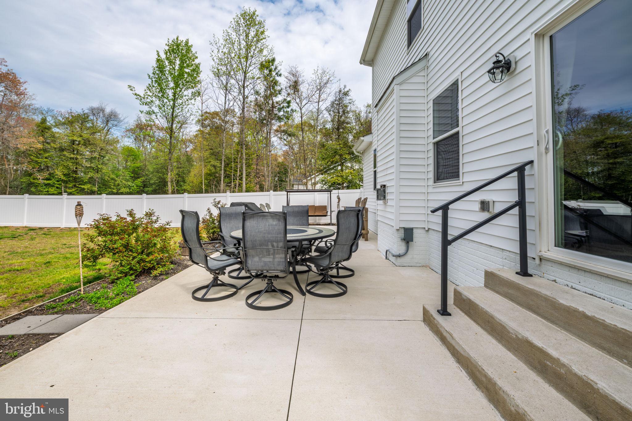 28008 King Farms Road Laurel, DE 19956 - Photo 35 of 44 a view of a patio with table and chairs potted plants and tree