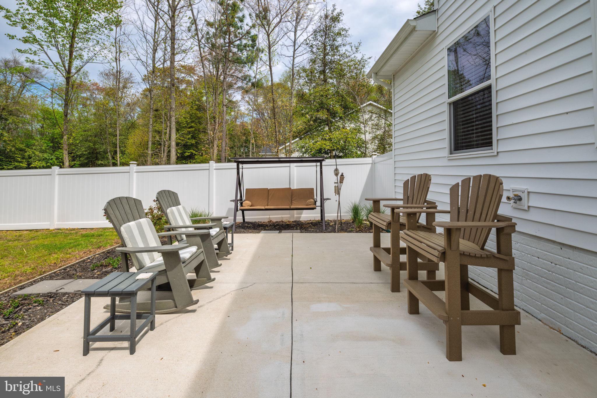 28008 King Farms Road Laurel, DE 19956 - Photo 37 of 44 a view of a patio with table and chairs with wooden floor and fence