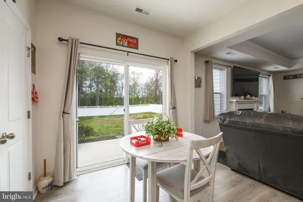 a dining room with furniture window and wooden floor