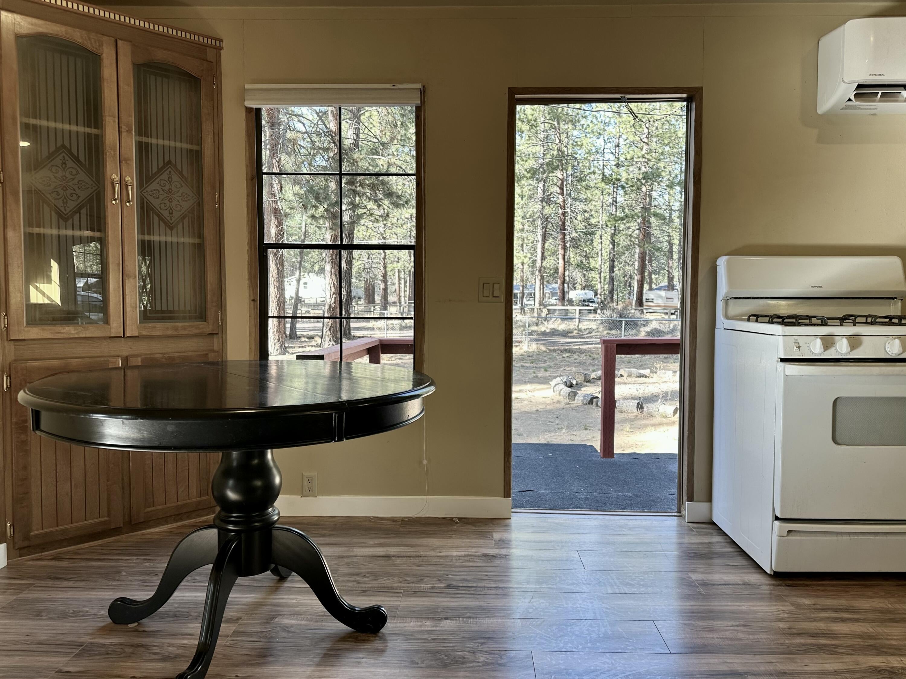 60083 Navajo Road Bend, OR 97702 - Photo 10 of 20 Dining area with built-in hutch and door to back deck