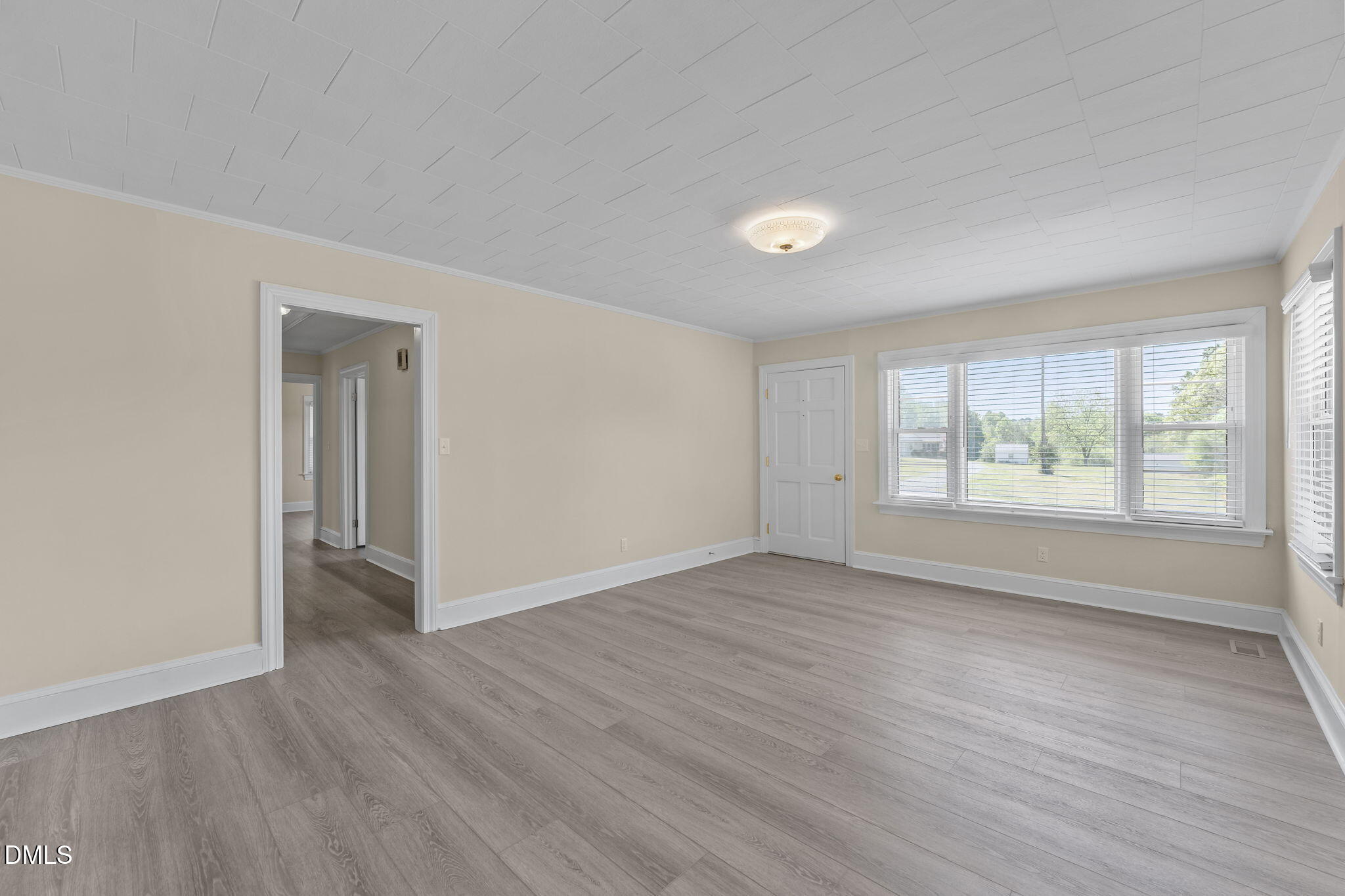 1723 Power Line Road Elon, NC 27244 - Photo 6 of 22 a view of an empty room with wooden floor and a window