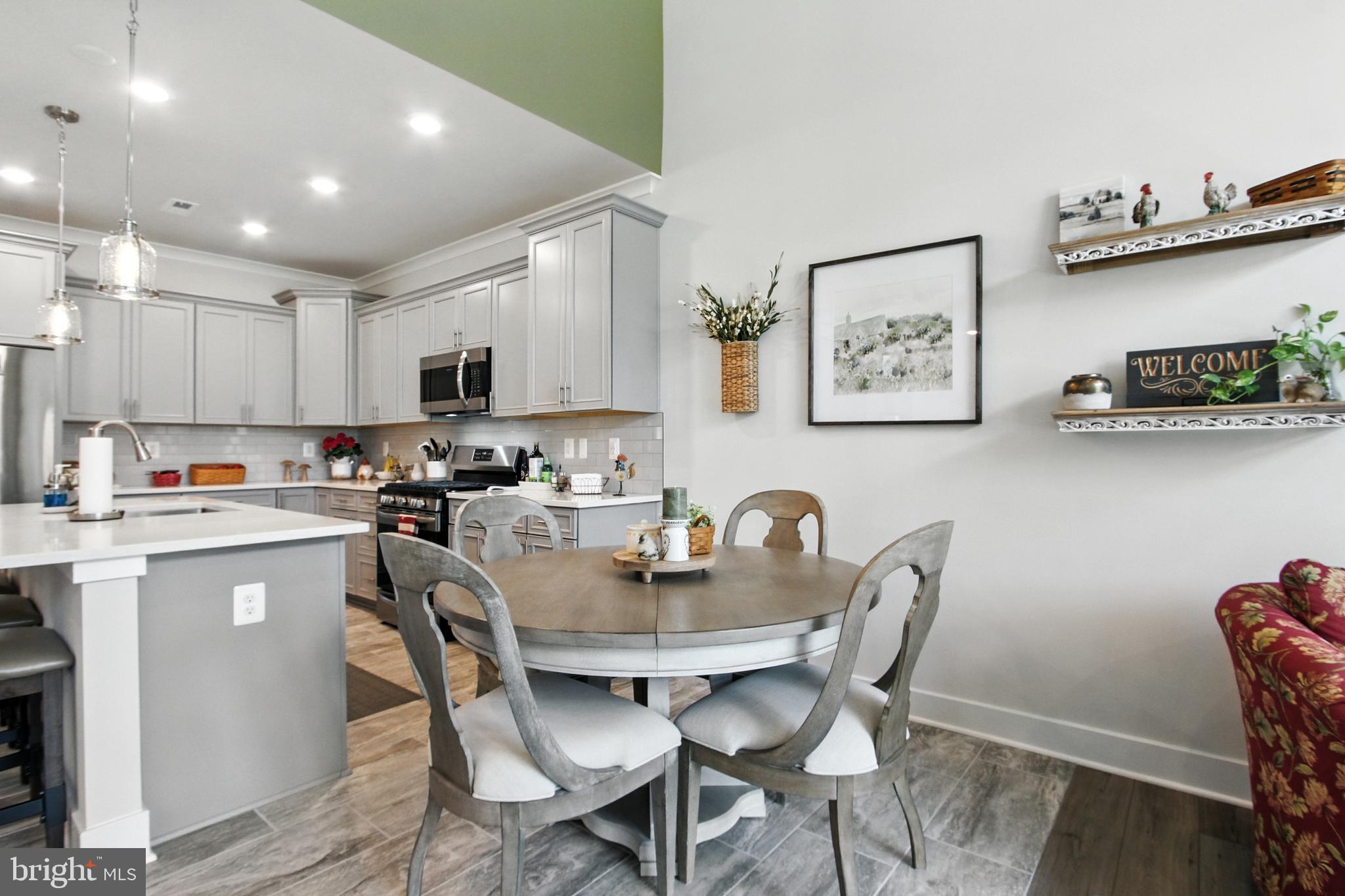 33 Tulip Tree Way Gettysburg, PA 17325 - Photo 6 of 34 a kitchen with a dining table chairs and white stainless steel appliances