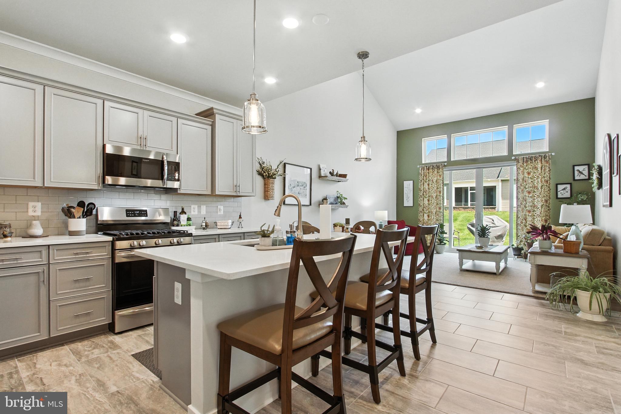 33 Tulip Tree Way Gettysburg, PA 17325 - Photo 8 of 34 a kitchen with stainless steel appliances kitchen island granite countertop a table chairs sink and cabinets