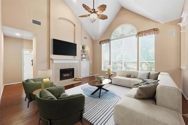 a living room with furniture a fireplace and a flat screen tv