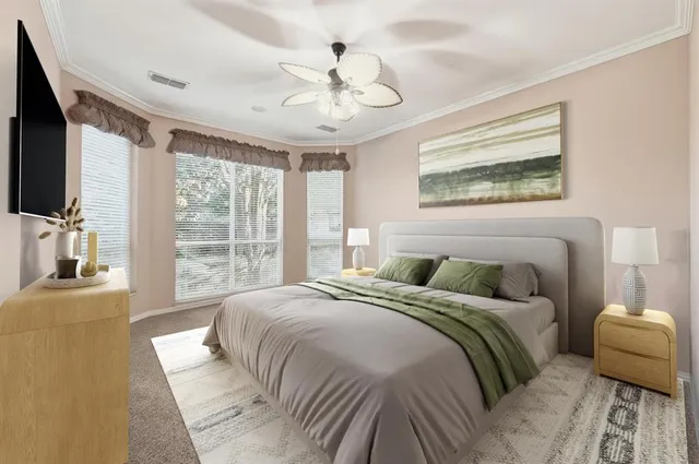 a bedroom with a large bed and a flat tv screen