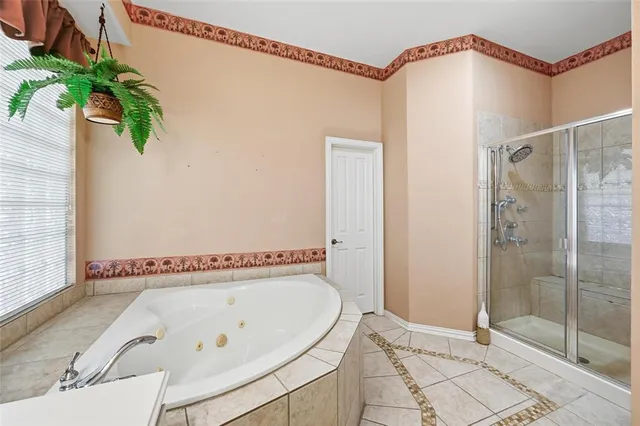 a bathroom with a tub and shower