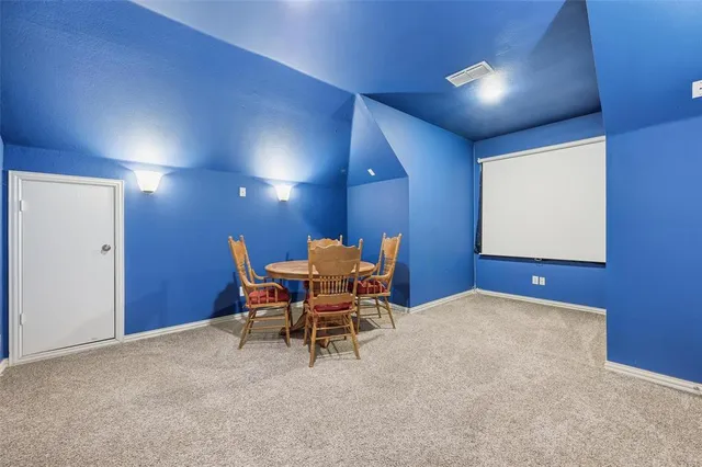 a dining room with furniture and a potted plant