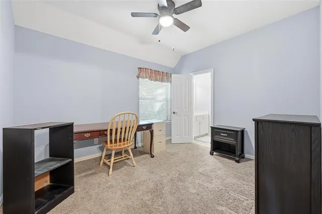 a living room with furniture a ceiling fan and a window