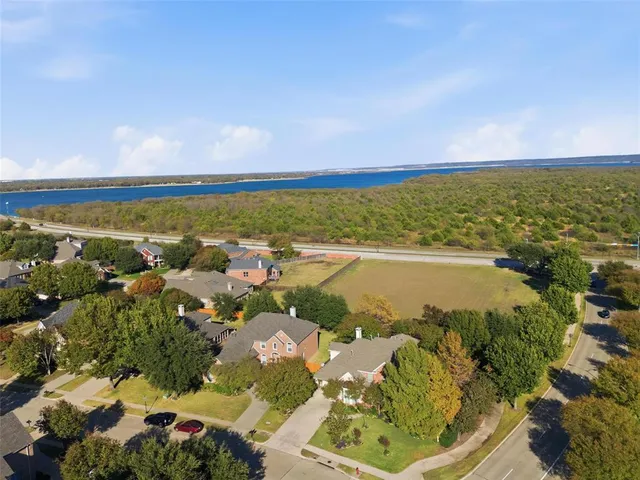 an aerial view of residential building and lake