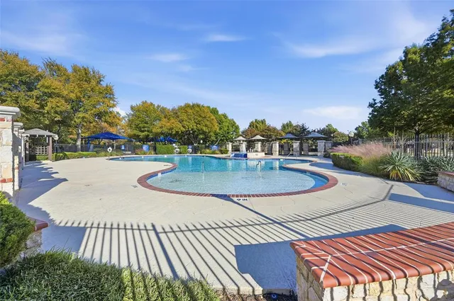 a view of a swimming pool with a patio