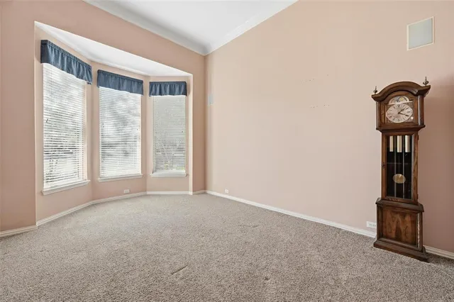 a view of a livingroom with a chandelier fan and a window