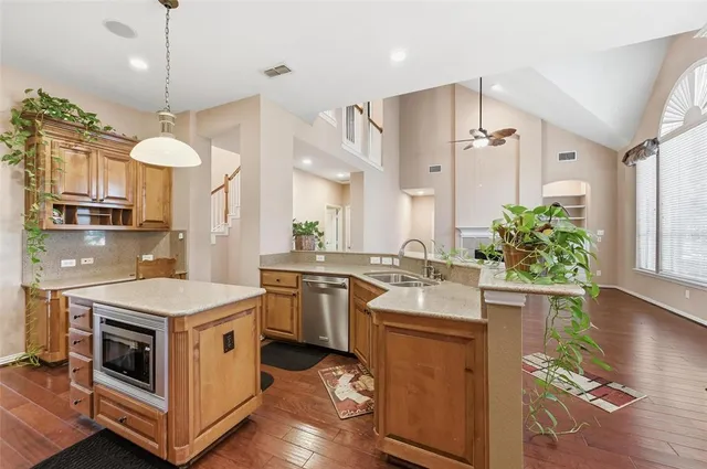 a kitchen with a stove a sink and a refrigerator