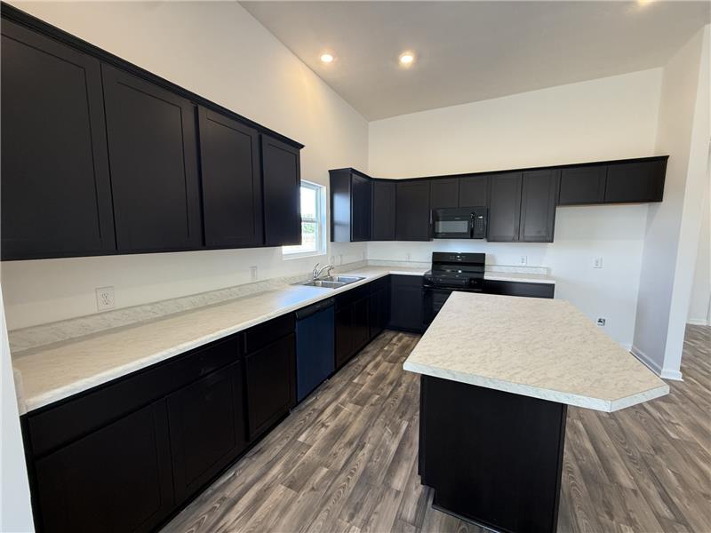 4001 Chakeres Avenue Springfield, OH 45505 - Photo 5 of 15 This spacious kitchen offers ample cabinet and counter space, ideal for culinary exploration and entertaining.