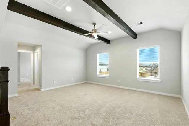 an empty room with a window and ceiling fan