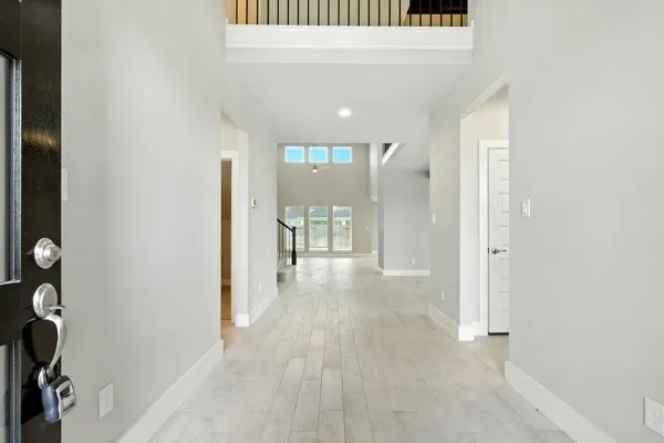 a view of a hallway with wooden shelves