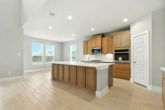 a kitchen with stainless steel appliances granite countertop a stove and a refrigerator