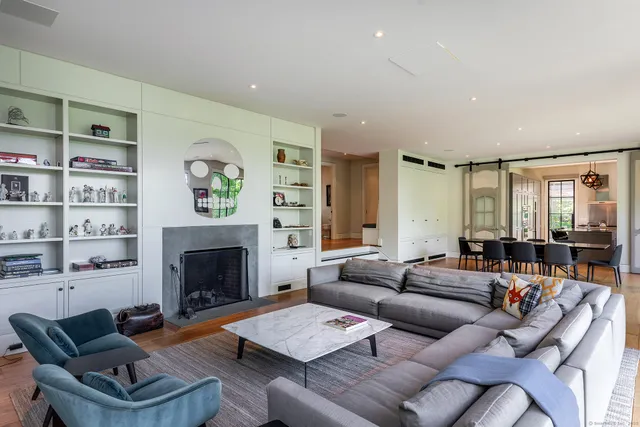 a view of a a dining room with furniture window and wooden floor