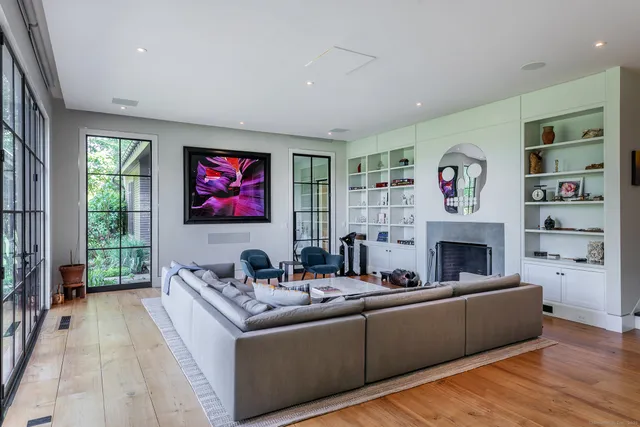 a kitchen that has a lot of cabinets a sink and appliances