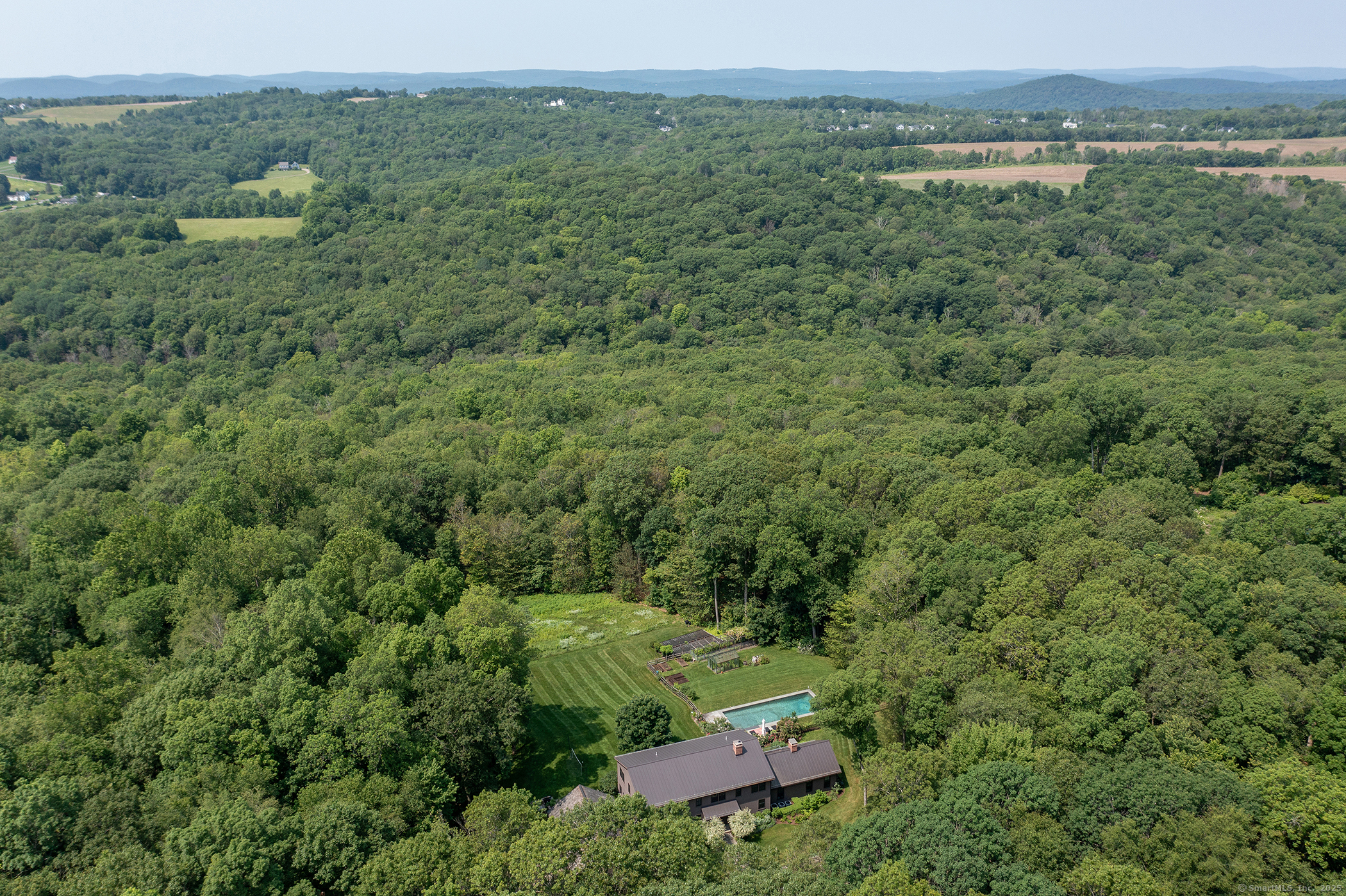 85 West Church Hill Road Washington, CT 06794 - Photo 4 of 38 a view of a lush green forest with trees and some houses