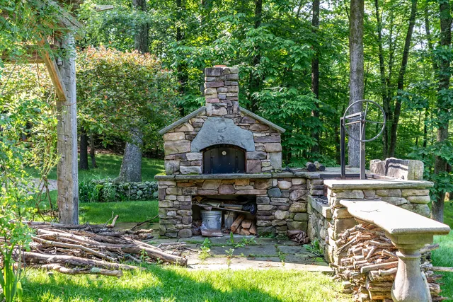 a living room with furniture large window and wooden floor