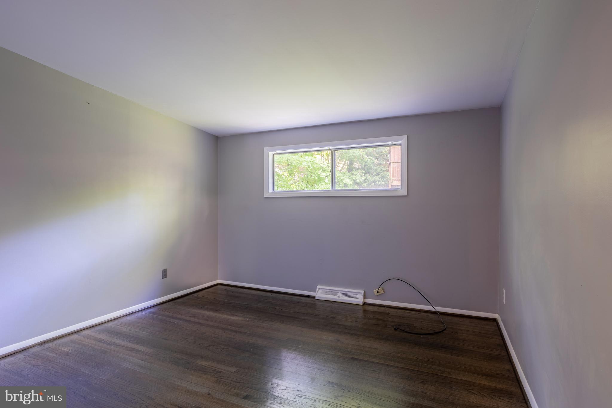 3207 Midfield Road Pikesville, MD 21208 - Photo 25 of 45 an empty room with wooden floor and windows