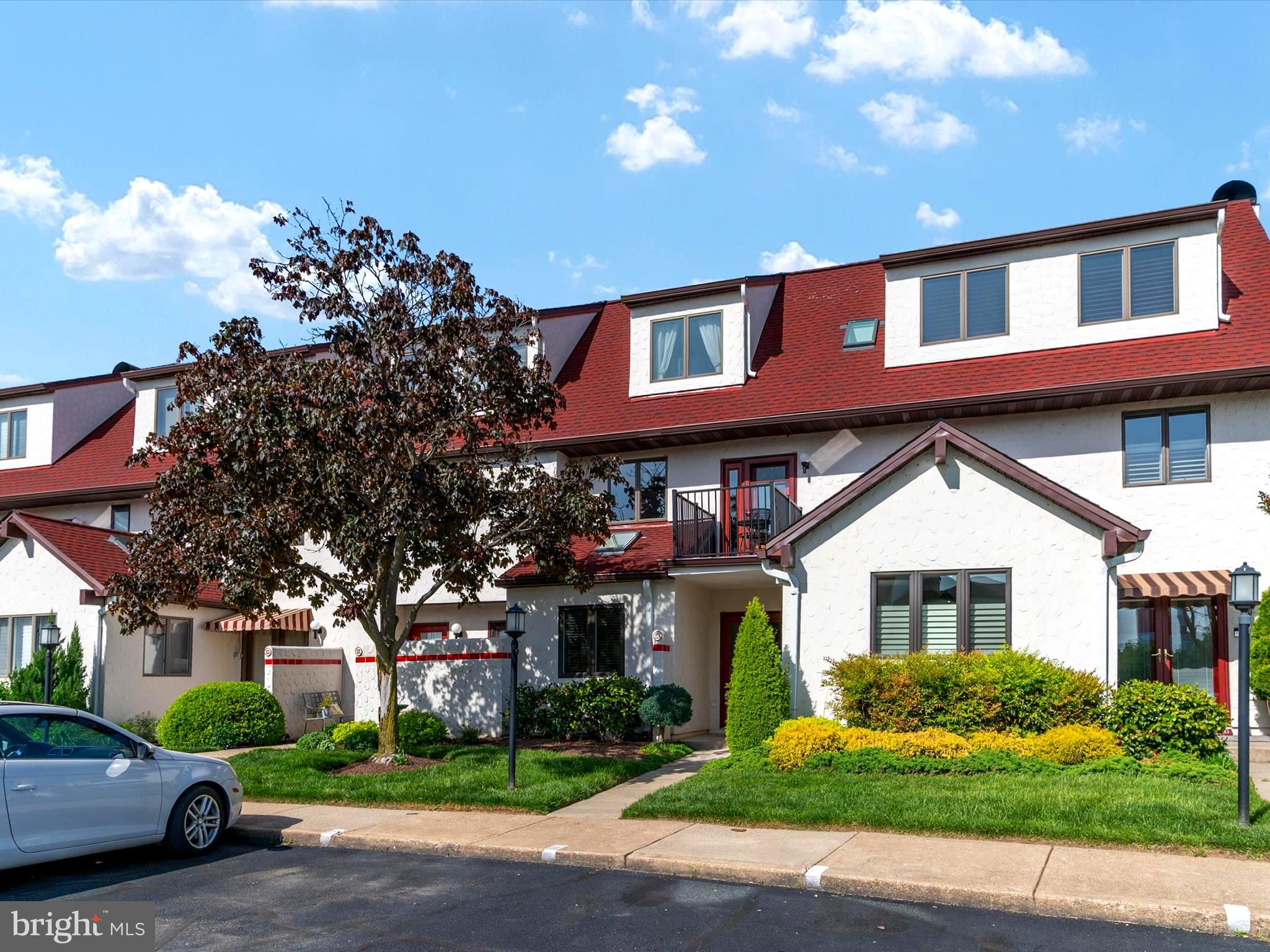 32 Queen Anne Way Chester, MD 21619 - Photo 57 of 61 a front view of a residential apartment building with a yard