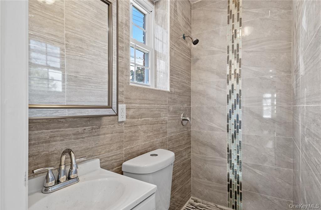 191-68 115th Road Queens, NY 11412 - Photo 16 of 20 a bathroom with a toilet a sink and shower