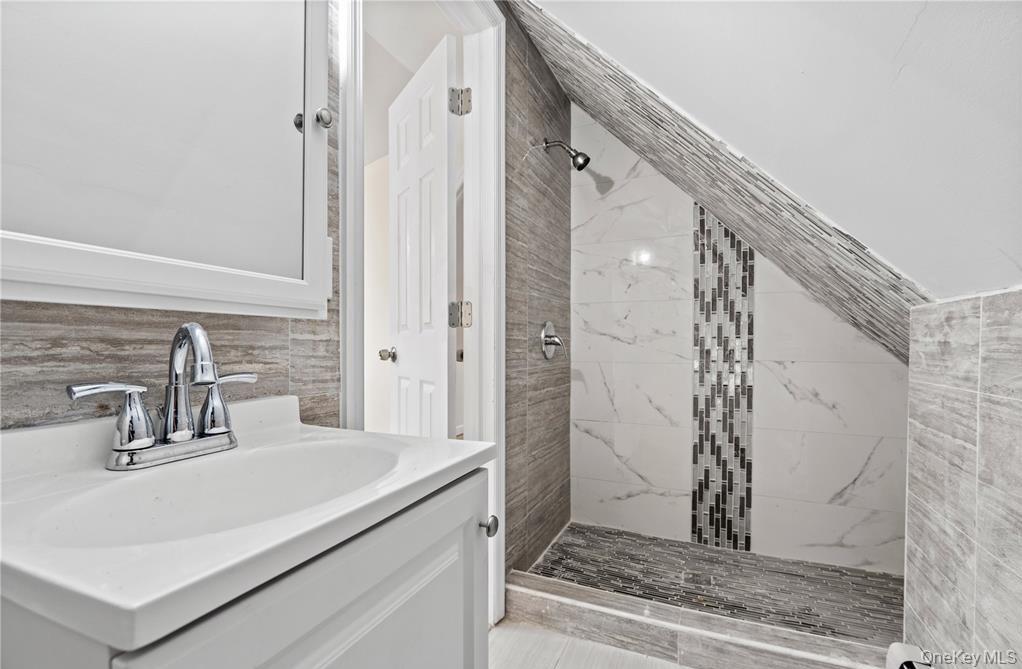 191-68 115th Road Queens, NY 11412 - Photo 19 of 20 a bathroom with a sink and a mirror